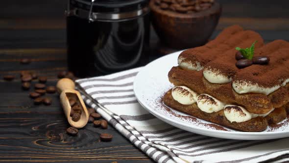 Classic Tiramisu Dessert and Coffee Grinder on Ceramic Plate on Wooden Background alt