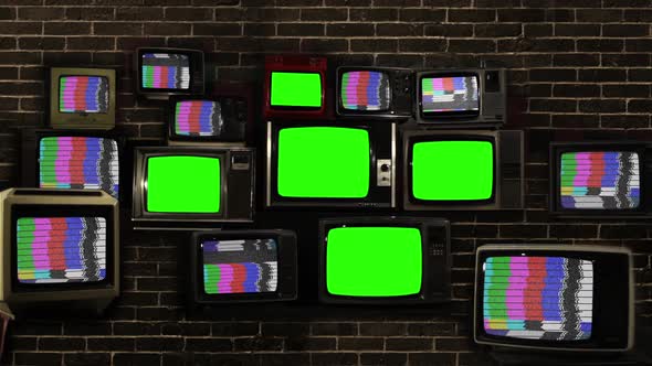 Five Old Televisions Turning On Green Screens Among Stacked TVs with Test Pattern Signal.