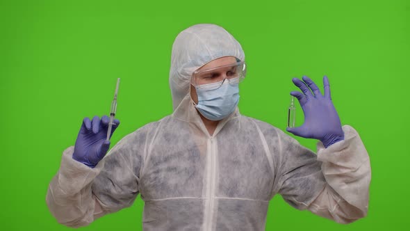 Doctor in PPE Suit with Vaccine Ampoule Syringe in Hands Offering Vaccination Against Coronavirus alt