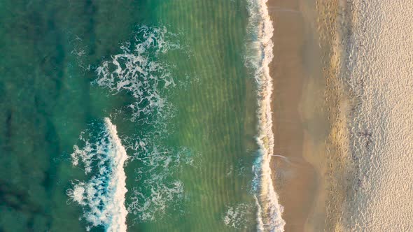 Aerial view of sea and sand beach on a sunny day. alt