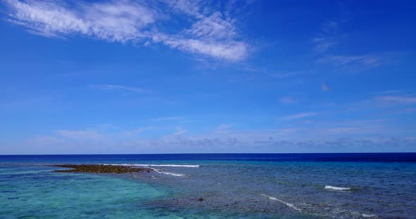 Beautiful drone copy space shot of a white sandy paradise beach and aqua blue water background in 4K alt