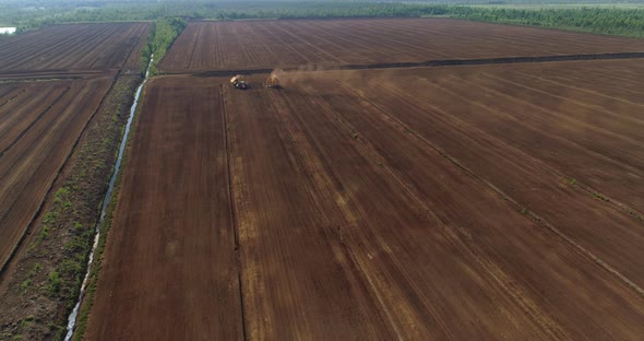 Peat Production in Harvesting Field in Drained Bog Aerial View alt