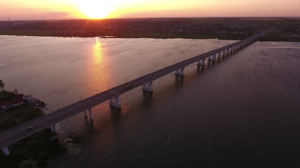 Aerial Shot of a Straight Bridge Over the Dnipro at a Violet Sunset in Summer