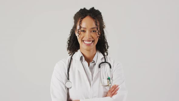Video of portrait of smiling biracial female doctor with arms crossed alt