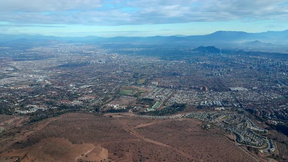 Pan left aerial view of the Las Condes district in Santiago, Chile. Morro Las Papas at Parque San Ca alt