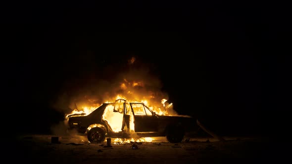 Car On Fire, Burning Car At Night, Side View, 4K Footage.