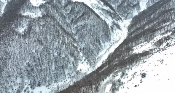 Aerial view of beautiful snowy mountains in Pasanauri, Georgia alt