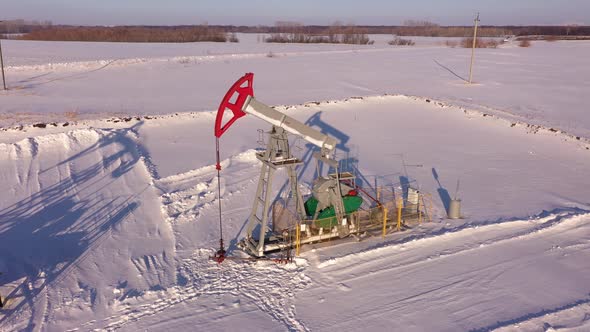 Pump Jack in Vast Oil Fields in Winter alt