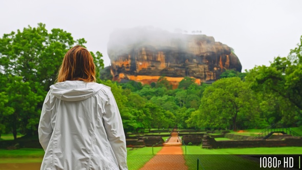 Following a Tourist Walking Towards Sigiriya Rock Temple in Sri Lanka During the Rainy Season