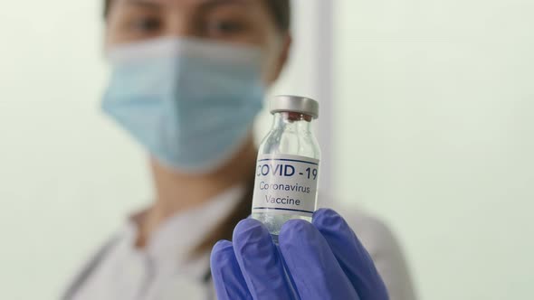 Closeup a Vial with the COVID19 Coronavirus Vaccine in the Hand of a Doctor alt