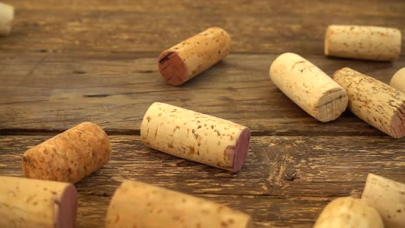 Falling wine corks on old wooden vintage boards. Slow motion. alt