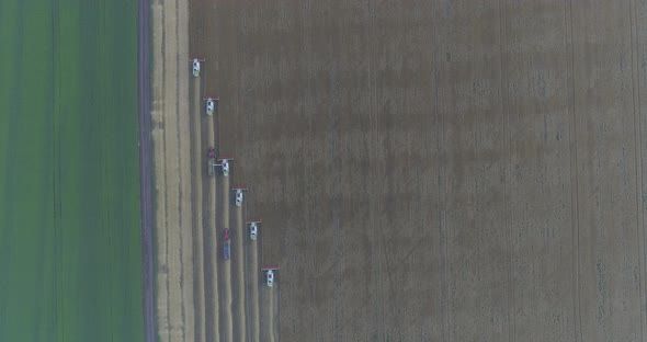 Threshers harvesting seen from above alt