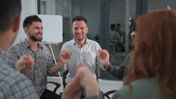 Support Team Young Successful Men and Women Staff Raise and Lower Their Arms Then Applaud Each Other alt