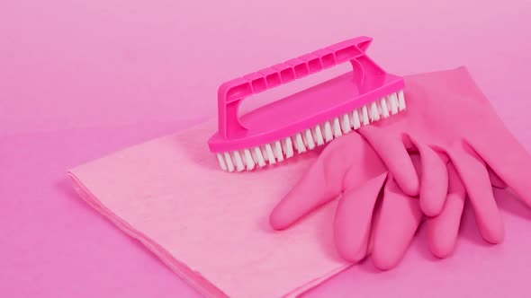 A Dust Rag Rubber Latex Gloves and a Pink Plastic Brush