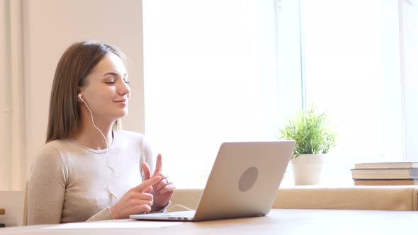 Female Designer Listening Music on Headphone alt