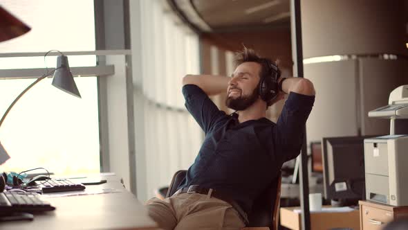 Man Relaxing In Office.Businessman Listening Music On Workplace Enjoy.Stress Free Man Relaxing alt