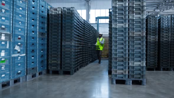Uniformed Storehouse Employee Checking Factory Product Shipment Boxes Counting alt