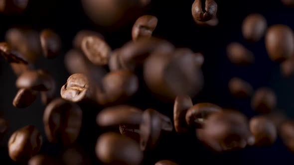 Roasted coffee beans in slow motion. Coffee beans in a free fall. alt