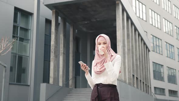 Close Up of Muslim Woman in Hijab with Modern Smartphone and Takeaway Coffee in alt