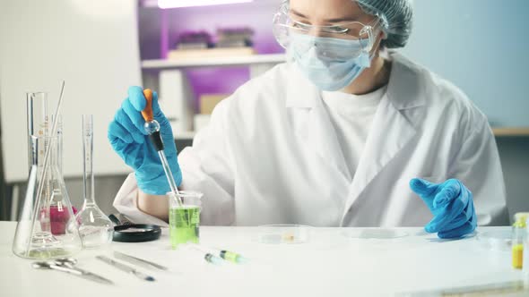 Medical Scientist Inspecting Minced Meat Wearing Protective Unform Working in Laboratory alt