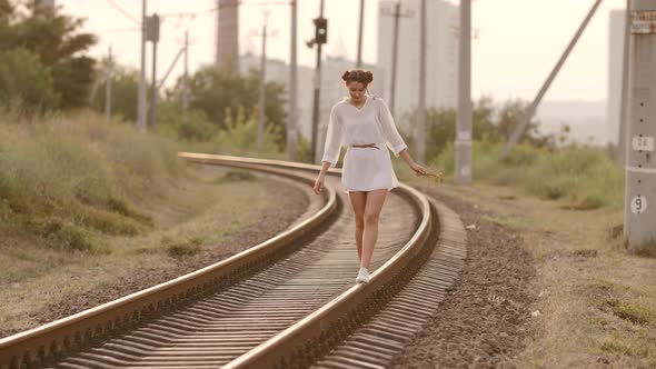 Woman Balancing on Train Rail, Beauty, Freedom, Summer Travel Concept alt