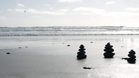 Rock Balancing on Ocean Beach Stones Stacking By Sea Water Waves