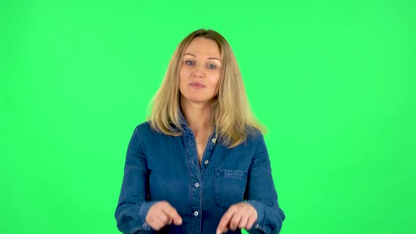Portrait of Fair Woman Is Smiling and Showing Heart with Fingers Then Blowing Kiss. Green Screen alt