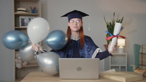 Modern Learning Happy Female Student in Mantle and Hat Rejoices at University Diploma with Balloons alt