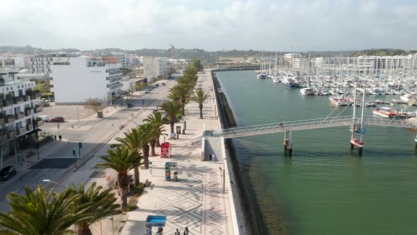 Aerial View of Lagos Algarve Streets Drone Lowering Down to Harbor Canal Portugal Day alt
