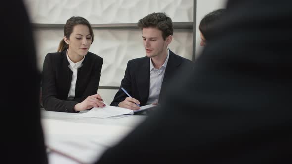 Young business people discussing in conference room alt