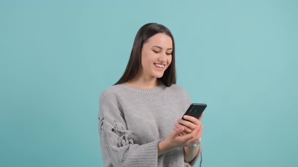 Close Up of an Young Woman Watching a Funny Video on Smartphone alt