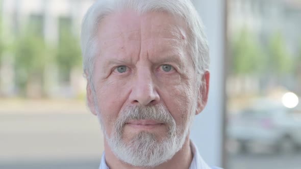 Close Up of Serious Old Man Outdoor alt