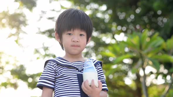 Asian Child Is Showing Dislike Drinking Milk Expression alt