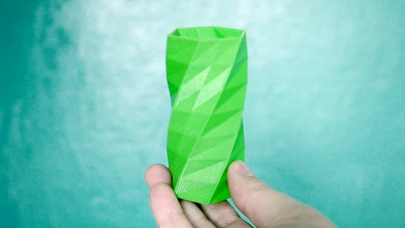 The Person Holds on His Hands and View Green Object Created on 3d Printer