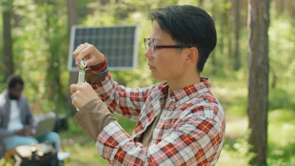 Scientist Putting Sample Into Tube alt