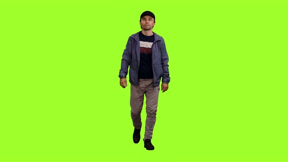 Walking Man in Casual Wear on Green Background alt