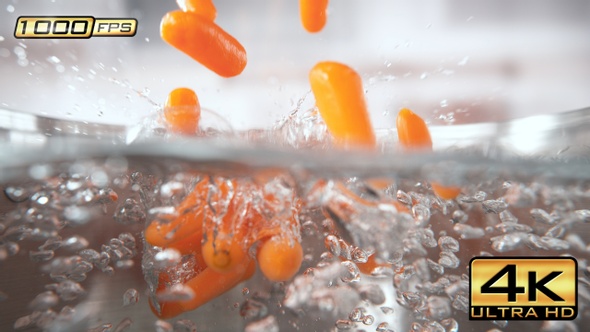 Baby Carrots Falling into Pot with Boiling Water alt