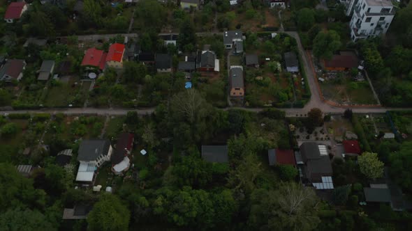Tilt Down View of Residential Houses with Gardens Next By Multistorey Buildings in Housing Estate alt