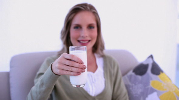 Gleeful Woman Drinking A Glass Of Milk