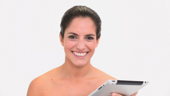 Amused Brunette Woman Using A Tablet Pc