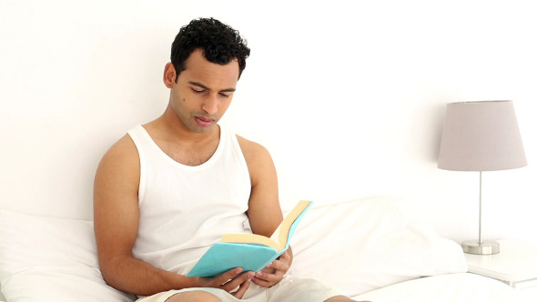 Happy Handsome Man Reading A Book