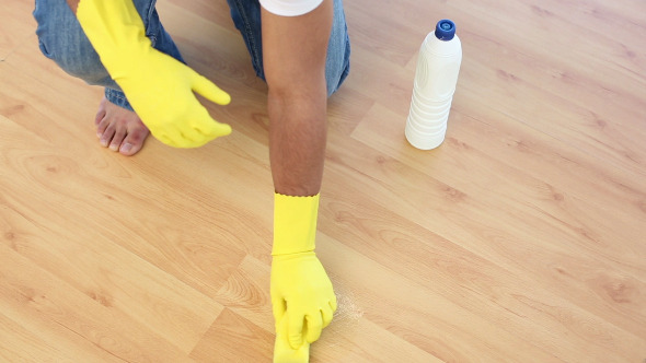 Man Cleaning Floor With Sponge