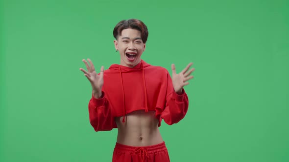 The Shocked Asian Transgender Male Grabbing Her Head While Saying Wow On Green Screen Studio alt