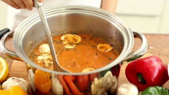 Woman Stirring Soup In A Saucepan