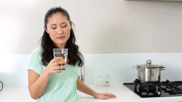 Smiling Woman Drinking Glass Of Water