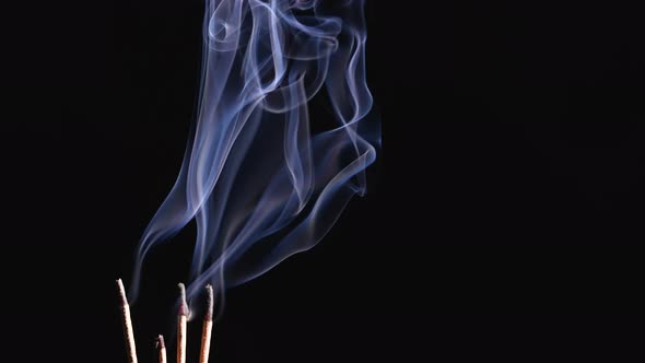 Burning Incense Sticks and Smoke Isolated on Black Background alt