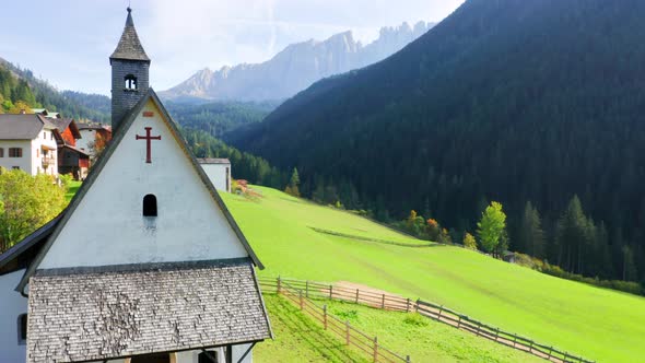 Gorgeous View Of Small Church At Green Alps With the Dolomites On The Background