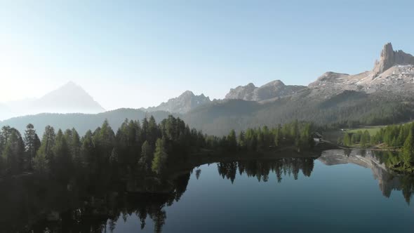 Aerial Flying over Mountain Lake Federa in Dolomites Alps Italy alt