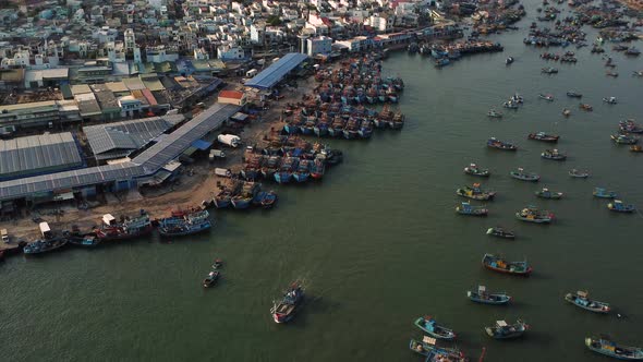 Aerial pan up, fishing town harbor in Southeast Asia. Overfishing overpopulation concept alt