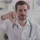 Portrait of Young Doctor Showing Thumbs Down Gesture